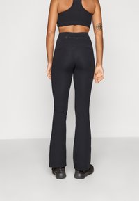 Champion TRAINING FLARE LEGGINGS INTERLOCK - Leggings - black