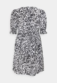 Robe à motifs noir et blanc avec col en V, manches bouffantes, taille élastique et jupe froncée à ourlet volanté.