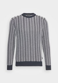 Pull en maille noir et blanc à manches longues avec un motif chevrons vertical, poignets, encolure et ourlet côtelés.