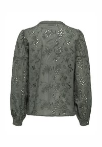 Blouse verte brodée avec des motifs floraux, des manches bouffantes et un col rond avec des détails découpés à l'arrière.
