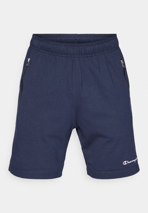 Tummansiniset shortsit, joissa on elastinen vyötärö, kaksi sivutaskua vetoketjulla ja pieni brodeerattu logo helman kohdalla. Pehmeä, joustava kangas.