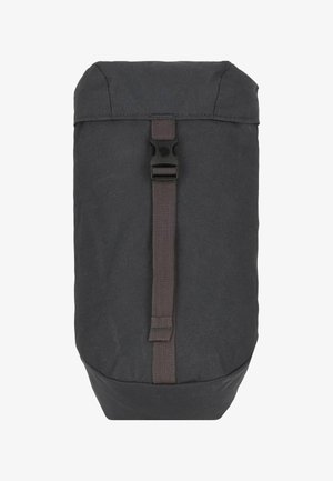 Sac à dos en tissu noir avec une base ronde, un rabat supérieur et une fermeture centrale par sangle. Texture mate avec une quincaillerie minimale et aucun motif visible.