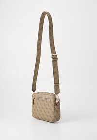 Beige crossbody bag with patterned fabric, a front zip pocket, and adjustable strap featuring logo design in brown tones. Silver hardware accents.