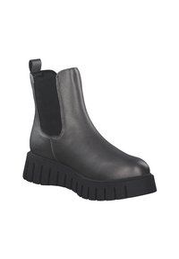 Stivale alla caviglia in pelle nera con pannelli elastici laterali e suola in gomma spessa e rigata. Texture liscia, punta rotonda e linguetta posteriore.