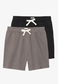 Two pairs of shorts: one gray and one black. Both have an elastic waistband with a white drawstring and a simple, smooth texture.
