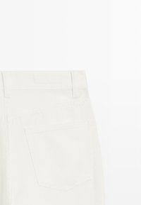 Białe spodnie dżinsowe o klasycznym kroju, z tylną kieszenią, szlufkami na pasek i gładką fakturą. Brak widocznych zdobień czy wzorów.