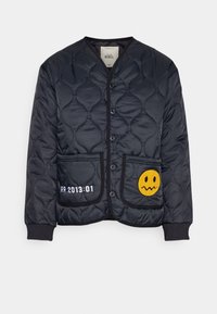 Veste bomber noire matelassée avec une finition lisse, dotée de boutons-pression, de deux poches avant et d'un patch avec un visage souriant jaune.