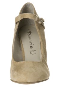 Béžová semišová botička Mary Jane s kulatou špičkou, nastavitelným páskem a jemnou vnitřní podšívkou. Obsahuje nízký podpatek a koženou stélku.