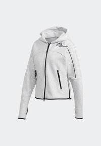 Sweat à capuche zippé Adidas gris clair avec des accents de fermeture éclair noirs, des poches avant et un petit logo sur la partie supérieure gauche de la poitrine.