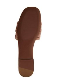 Brown shoe sole with a textured grip pattern, featuring a flat shape and a smooth finish. Includes a brand logo near the heel.