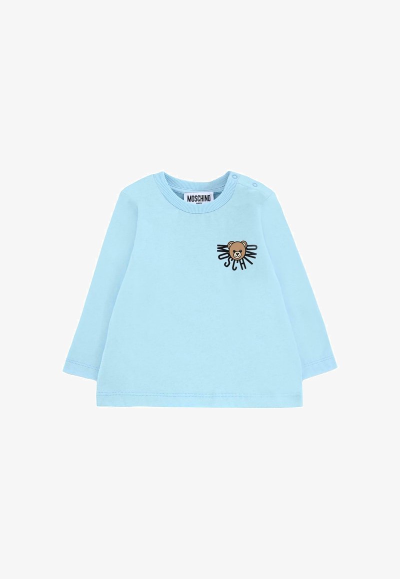 Jasnoniebieska koszula z długim rękawem z miękkiej bawełny, z grafiką niedźwiedzia i tekstem z przodu. Zawiera zatrzaski na ramieniu.
