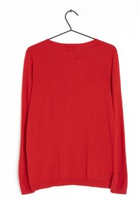 Red knitted sweater with long sleeves, round neckline, and ribbed hem. Smooth texture and solid color, hanging from a black metal hook.