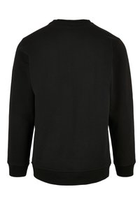 Maglione nero a girocollo con maniche lunghe, polsini e orlo a coste, realizzato in un morbido tessuto dalla superficie liscia, in un colore uniforme.
