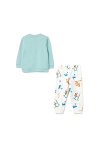 Top de manga larga azul claro y pantalones blancos con estampados y patrones de animales coloridos. Tejido suave con cinturilla elástica en los pantalones.
