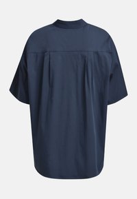 Navy oversized shirt with a high collar, short sleeves, and back pleats. Made of smooth fabric with a clean finish.