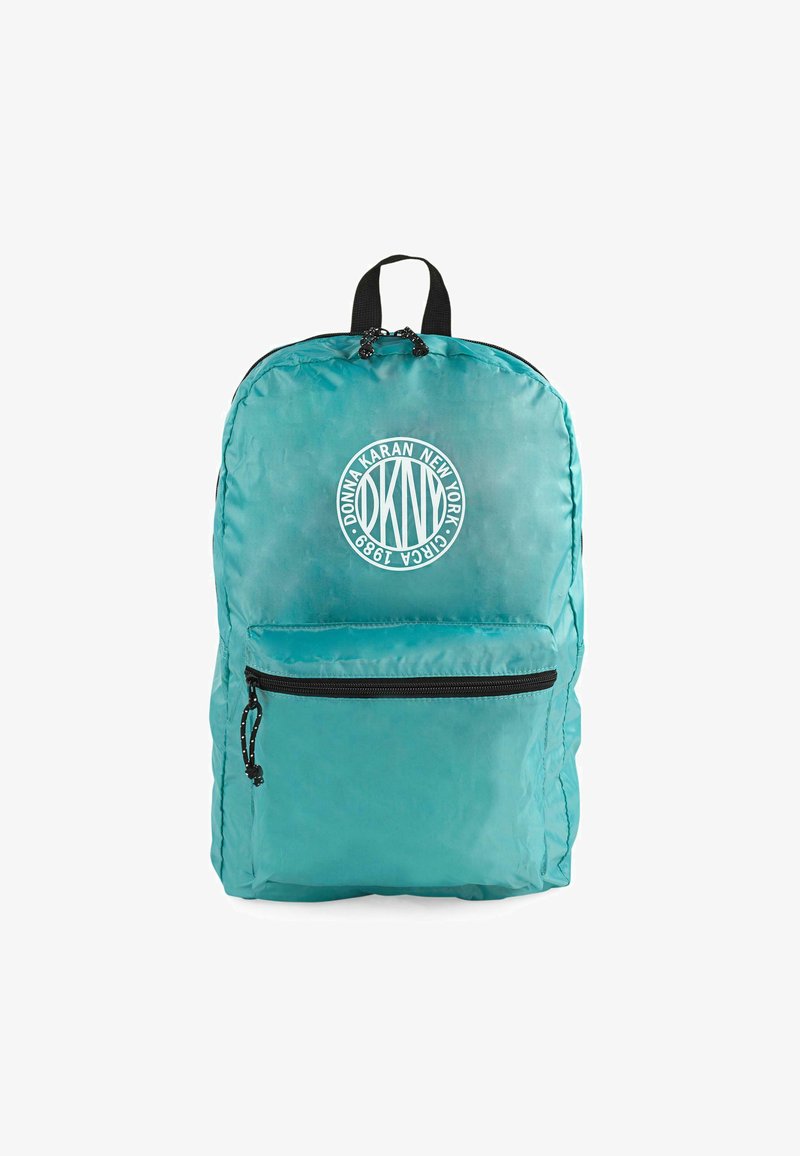 Mochila de nylon en tono aguamarina con forma redondeada, un bolsillo frontal con cremallera y un logotipo circular en blanco que muestra "DKNY" y "1998." Accentos en negro en las correas.