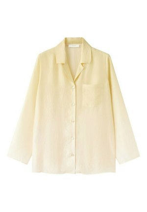 Svetložltá košeľa s dlhým rukávom, zapínaná na gombíky, s golierom a náprsným vreckom, vyrobená z ľahkej textúrovanej tkaniny.