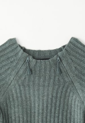 Maglione verde a coste con colletto alto, caratterizzato da cordini regolabili sul colletto, realizzato in un tessuto testurizzato.