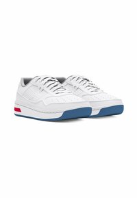 White leather low-top sneakers featuring perforated accents, grey lining, and a heightened white sole with blue and red detailing.
