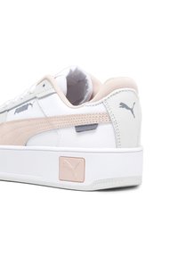 Sneaker bianca con accenti rosa e grigi, tomaia in pelle testurizzata, collare imbottito, soletta in gomma e un logo Puma prominente sul lato.
