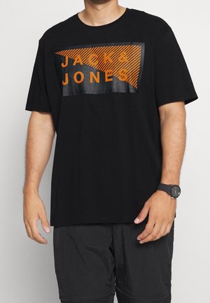 Black T-shirt with orange and black graphic print displaying "JACK & JONES." Short sleeves, loose fit, cotton material, smooth texture.