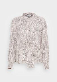 Blouse à manches longues de couleur beige clair avec un motif abstrait noir, dotée d'un col et d'un détail noué à l'avant, ainsi que des poignets froncés.