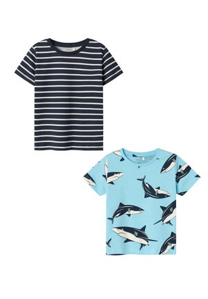 Two T-shirts: one navy with white horizontal stripes, the other light blue featuring black shark graphics. Short sleeves and round neck.