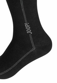 Calzino nero in tessuto strutturato, con cucitura a contrasto e dettagli in cucitura grigia, dal design elegante e aderente.