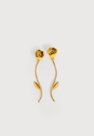 Gold-tone earrings shaped like flowers with curved stems and a single leaf on each stem, against a white background.