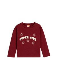 Burgundy pitkähihaista paitaa, jossa on "SUPER GIRL" -teksti ja tähtigrafiikkaa vaaleassa sävyssä. Pehmeä puuvillamateriaali, pyöreä kaula-aukko ja rento istuvuus.