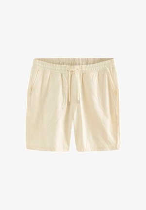 Jasno beżowe szorty z elastycznym paskiem, zawiązywaniem na sznurki oraz subtelnymi wzorami liści wytłoczonymi na tkaninie. Zawierają kieszenie po bokach.
