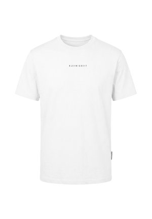 T-shirt blanc à manches courtes avec un petit texte noir « KLEINIGKEIT » centré sur la poitrine et une petite étiquette latérale sur la couture gauche.