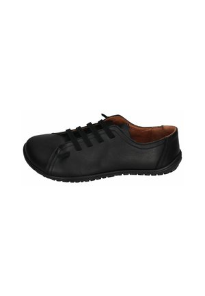 Black leather shoe with a rounded toe, featuring elastic bands instead of laces and a textured rubber sole. Interior lined with brown material.