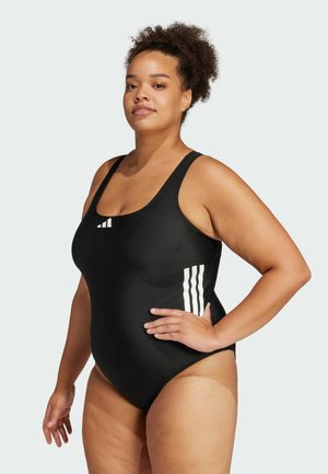 Zwarte tankini met brede banden, gladde textuur, met drie witte diagonale strepen aan de zijkant.