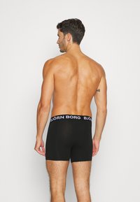 Schwarze Boxerbriefs mit einem breiten elastischen Bund, auf dem das Logo "BJÖRN BORG" zu sehen ist. Das Material wirkt glatt und enganliegend und zeigt ein schlichtes Design.