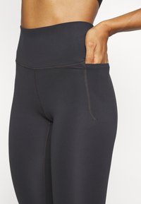 Under Armour MERIDIAN - Leggings - black