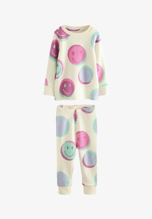 Set s dlouhým rukávem a kalhotami vyrobený z měkké tkaniny, smetanového pozadí, se velkými vícebarevnými úsměvy v růžových a modrých odstínech.