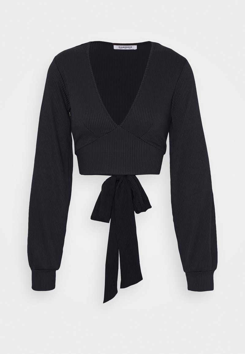 Svart ribbet crop top med lange ermer, dyp V-hals og en knyting i livet. Har et strukturert stoff for ekstra dimensjon.
