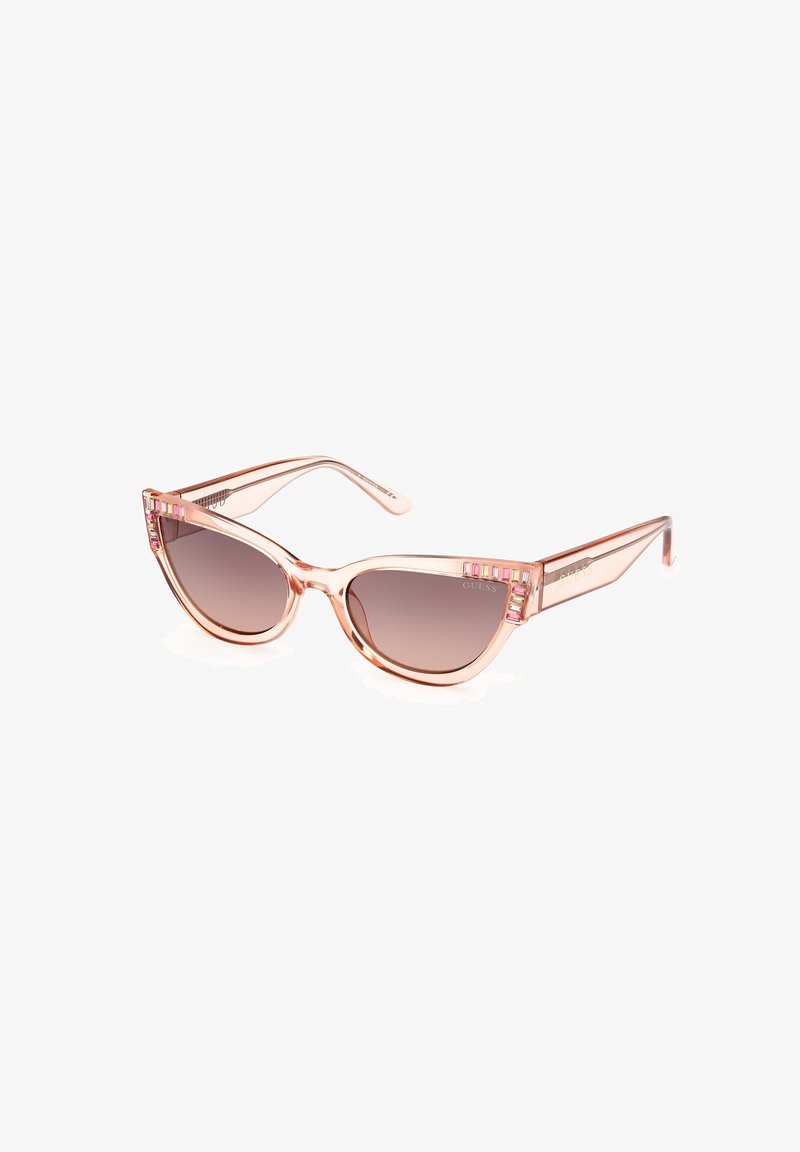 Gafas de sol de ojo de gato con un marco translúcido de color rosa, lentes marrones degradados y acentos decorativos de colores en las patillas.
