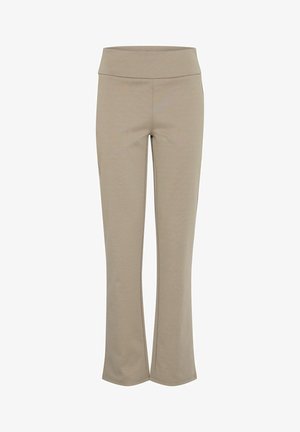 Pantalons de sport beiges avec une taille large, des jambes légèrement évasées et une texture lisse et douce. Aucun motif visible ni détail en métal.