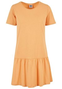 Robe décontractée couleur pêche à manches courtes avec un col rond et un détail de jupe froncée en bas.