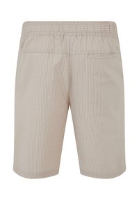 Shorts beige avec un motif texturé, une taille élastique et une poche arrière. Le tissu semble léger et respirant.