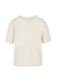 Cream-colored short-sleeve t-shirt in soft cotton fabric with a round neckline and a relaxed fit, featuring a plain back without logos or details.