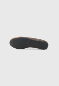 Shoe sole featuring a textured black rubber bottom and a brown patterned upper section, designed for grip and durability.