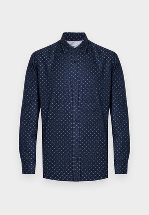 Chemise bleu marine à boutons, manches longues, avec un délicat motif losange blanc. Fabriquée en tissu lisse avec un col classique.