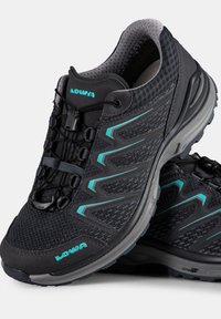 Black athletic shoes with a textured mesh upper, turquoise accents, and a durable sole. Features a quick-lace system for easy adjustment.