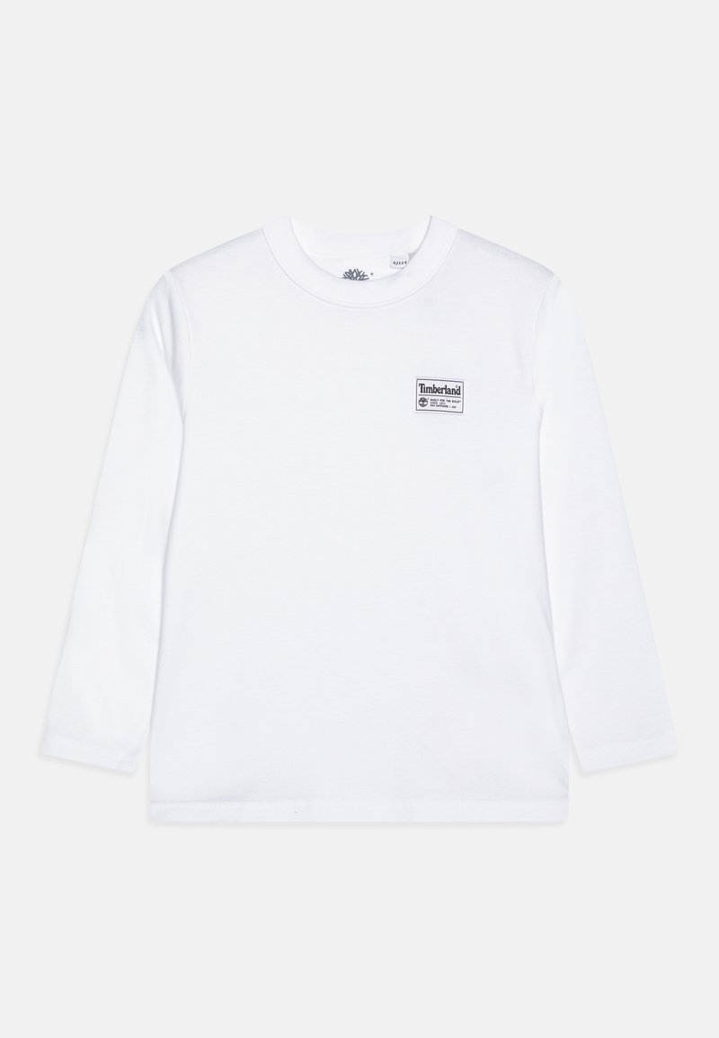 T-shirt blanc à manches longues en coton, avec un patch logo Timberland noir sur la poitrine gauche. Encolure arrondie, coupe standard.