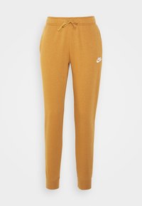 Gul-orange Nike sweatpants med elastisk midja och justerbar dragsko. Har en liten vit logotyp på övre vänstra ben.