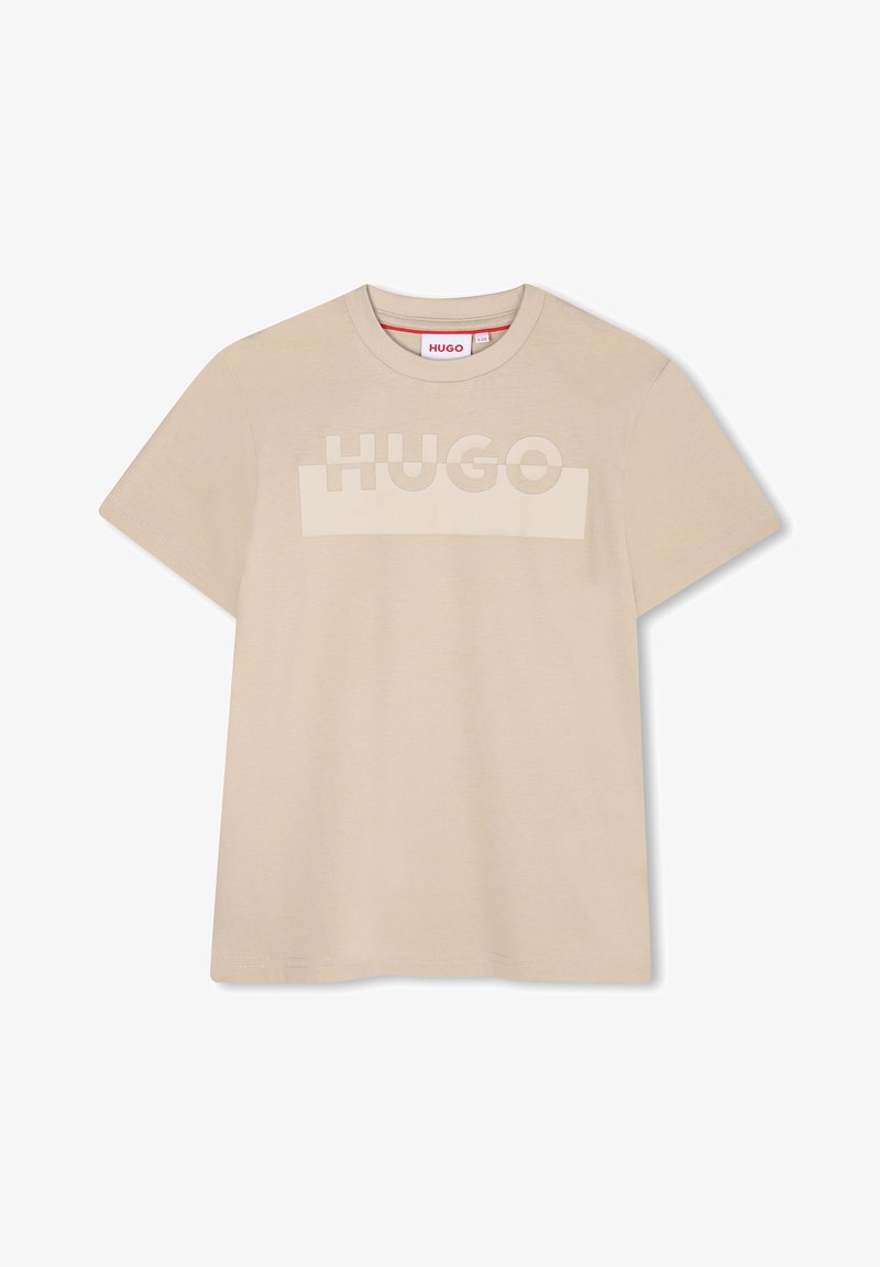 T-shirt en coton beige avec un logo "HUGO" ton sur ton sur la poitrine, col rond et manches courtes. Texture lisse avec une coupe décontractée.