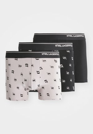Męski zestaw bokserek w kolorze czarnym i jasnoszarym, z wzorami twarzy w kolorze czarnym. Elastyczny pas z oznaczeniem "KARL LAGERFELD".